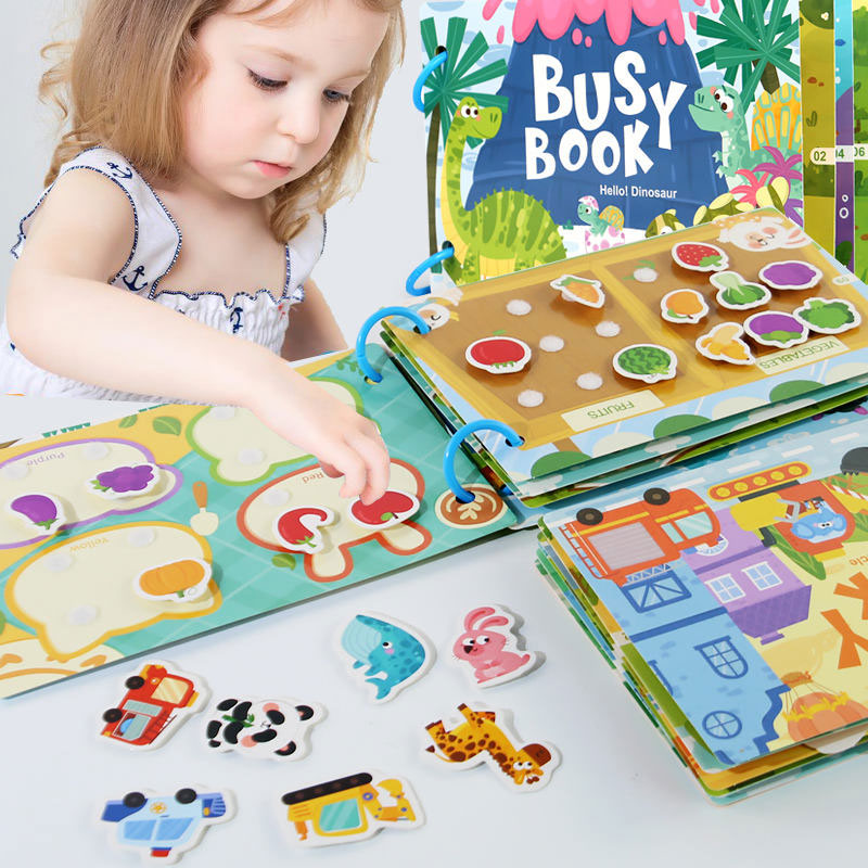 Child playing with a colorful Busy Book with various educational activities.
